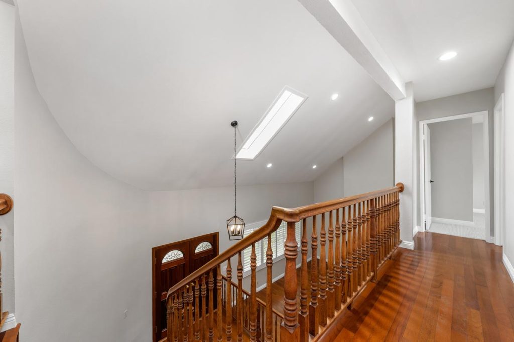 upstairs landing showing dark wooden floors and railing