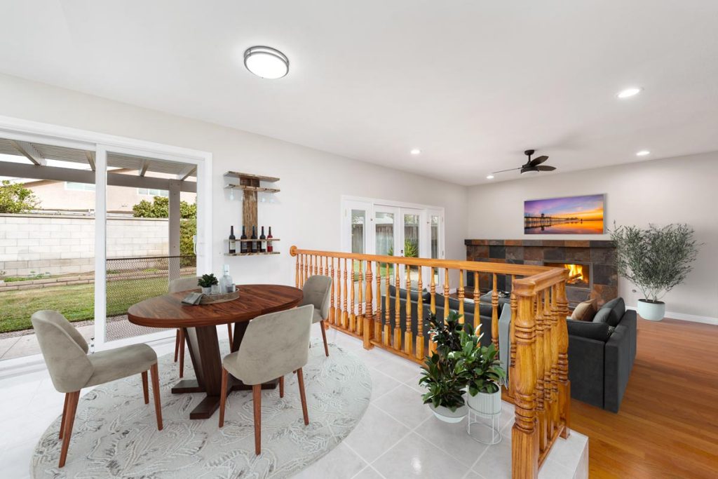 living room and dining area combined, staged with dining table and in the background a fireplace and couch