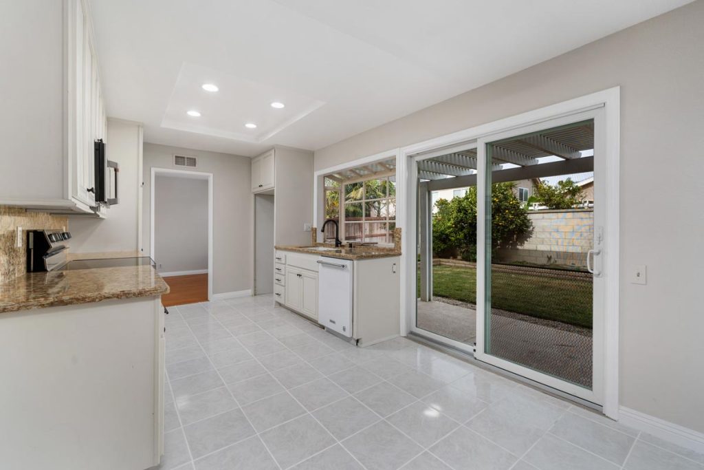 galley style kitchen showing sliding glass doors to backyard