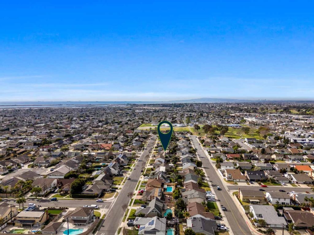 aerial view of 6371 Athena Drive, Huntington Beach with ocean in background and arrow pointing to house.