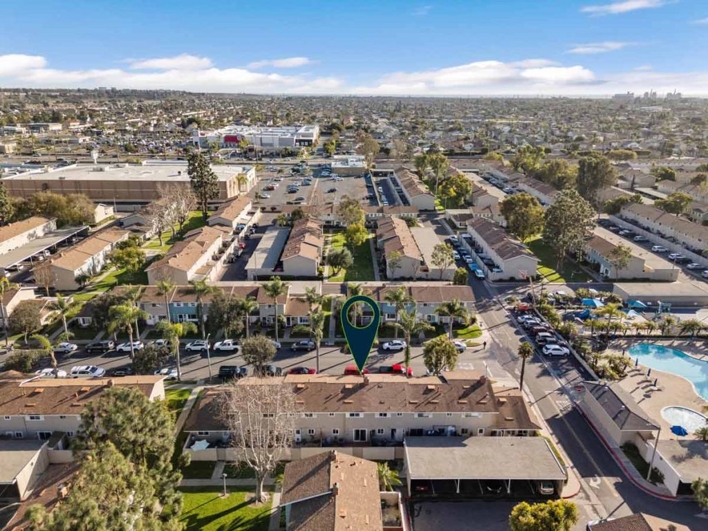 aerial view of townhome community with arrow pointing to unit for sale