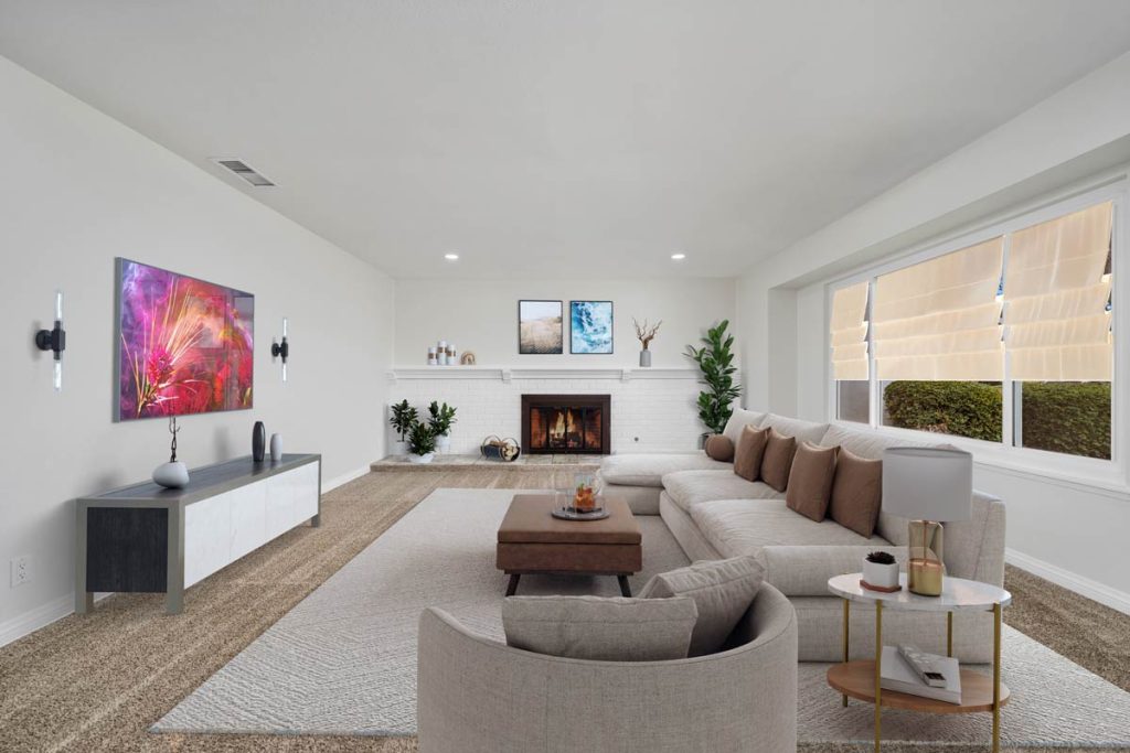 staged living room with couch, coffee table, and artwork on the wall