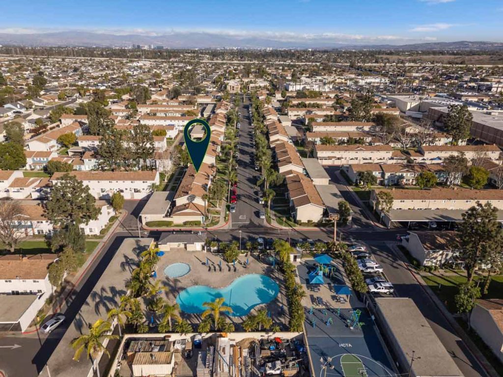 aerial view with arrow pointing to townhome unit within a community