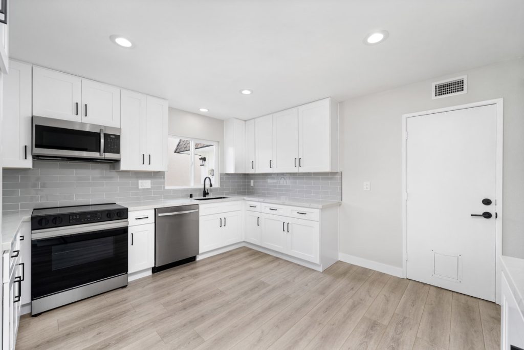 updated kitchen at 14522 Petsworth Lane, Westminster with white cabinets and countertops