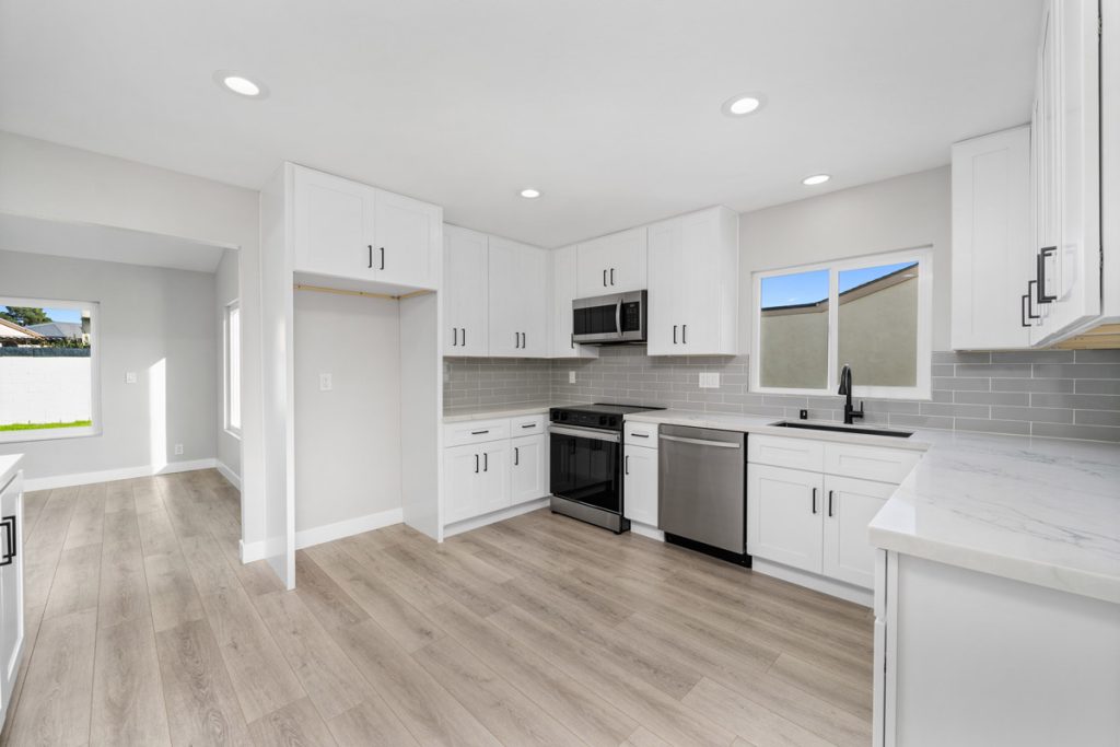 updated kitchen at 14522 Petsworth Lane, Westminster with white cabinets and countertops