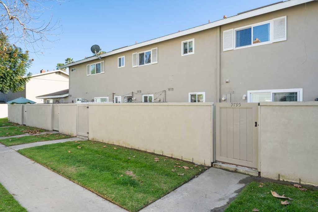 exterior rear of 9795 Continental Drive, Huntington Beach showing block wall with gates