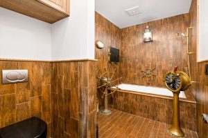 bathroom with wood walls and nautical accents