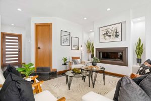 furnished room with fireplace, coffee table and chairs