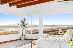 corner of windows viewing the sand and ocean