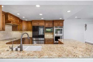 kitchen with wood toned cabinets, granite countertops and stainless appliances