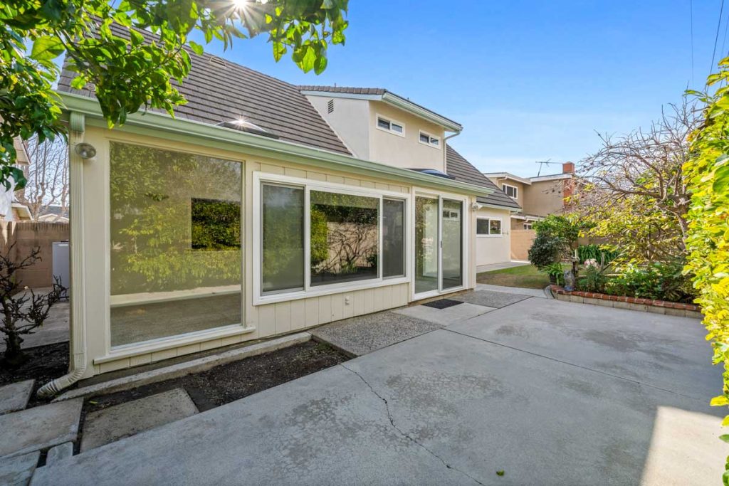 backyard patio showing concrete and house with windows