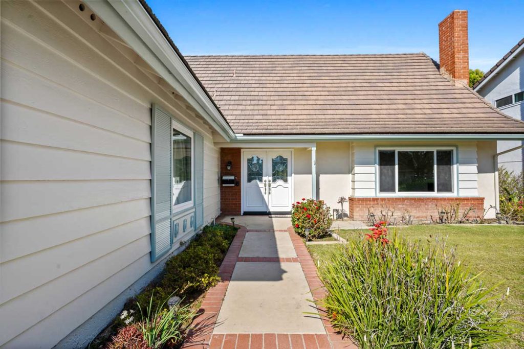 exterior entry, showing manicured walkway to double front doors