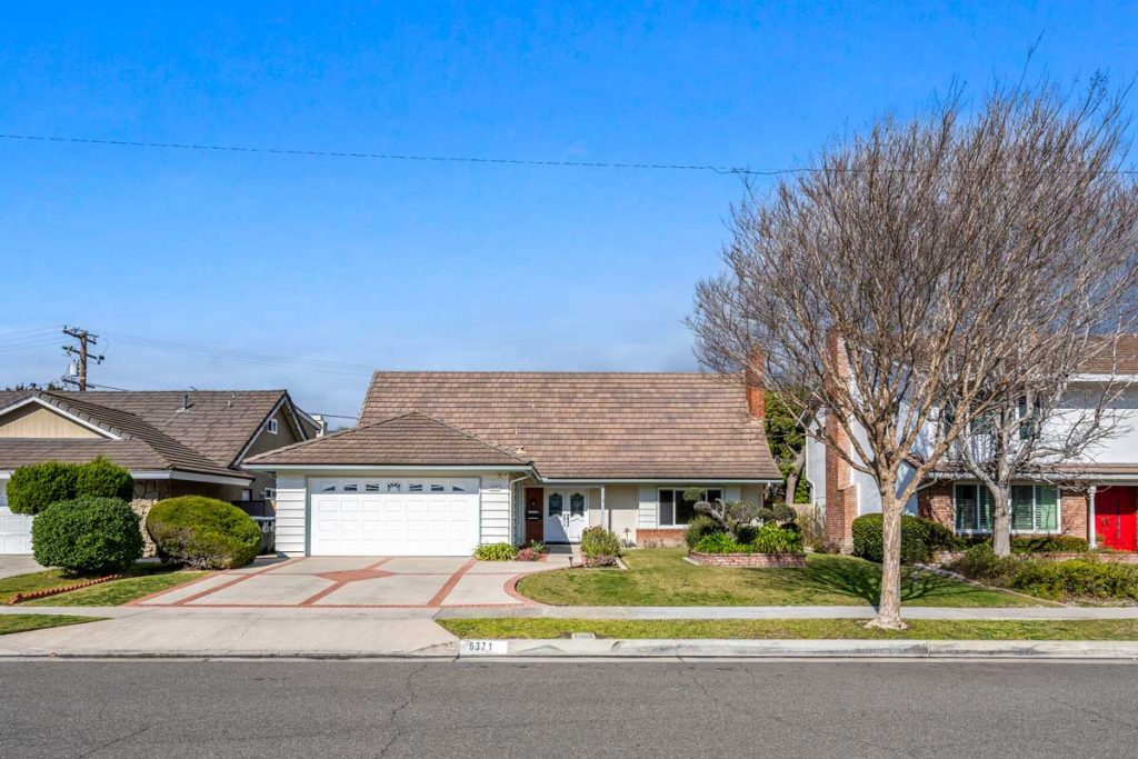 exterior of home painted white with tan roof shingles