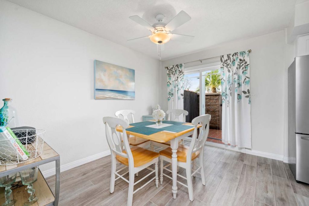 dining space with table for four, and a sliding door leading to back patio