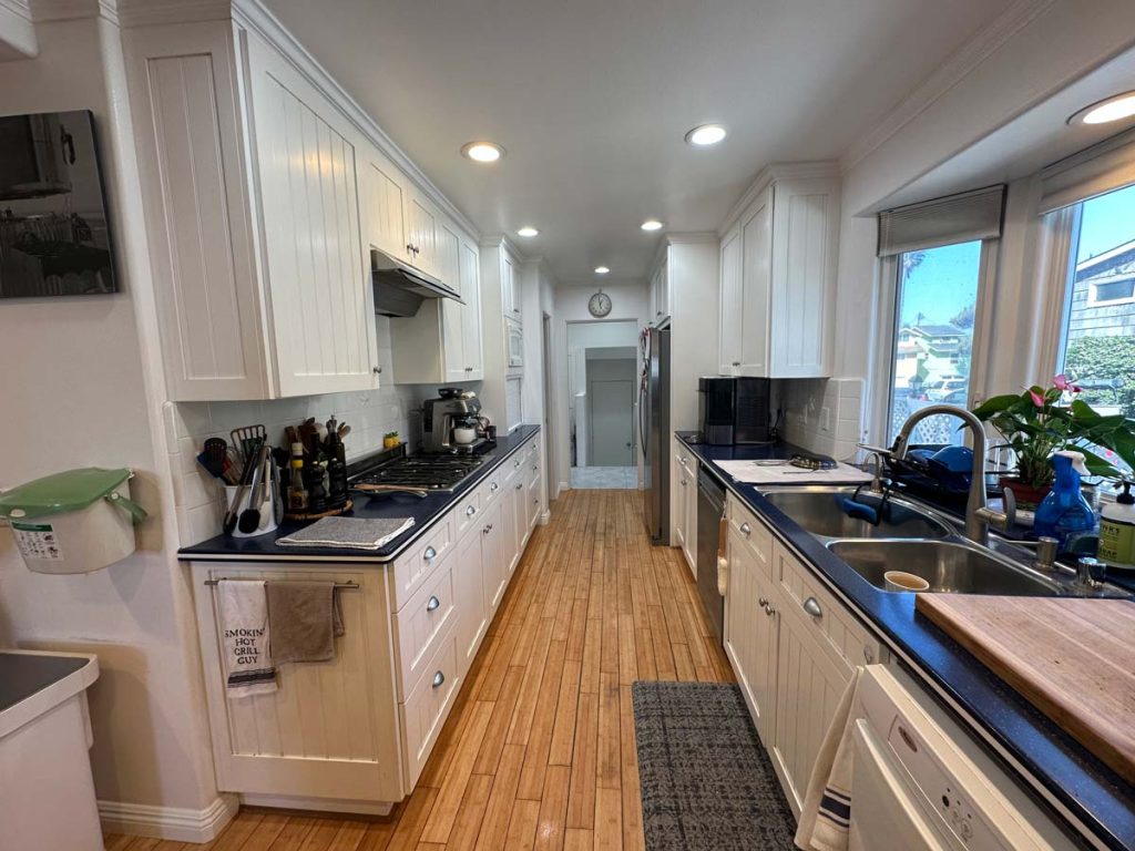 well-appointed kitchen with plenty of cabinet and counter space, gas cooktop stove, walk-in pantry and double ovens