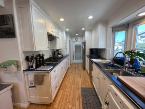 well-appointed kitchen with plenty of cabinet and counter space, gas cooktop stove, walk-in pantry and double ovens