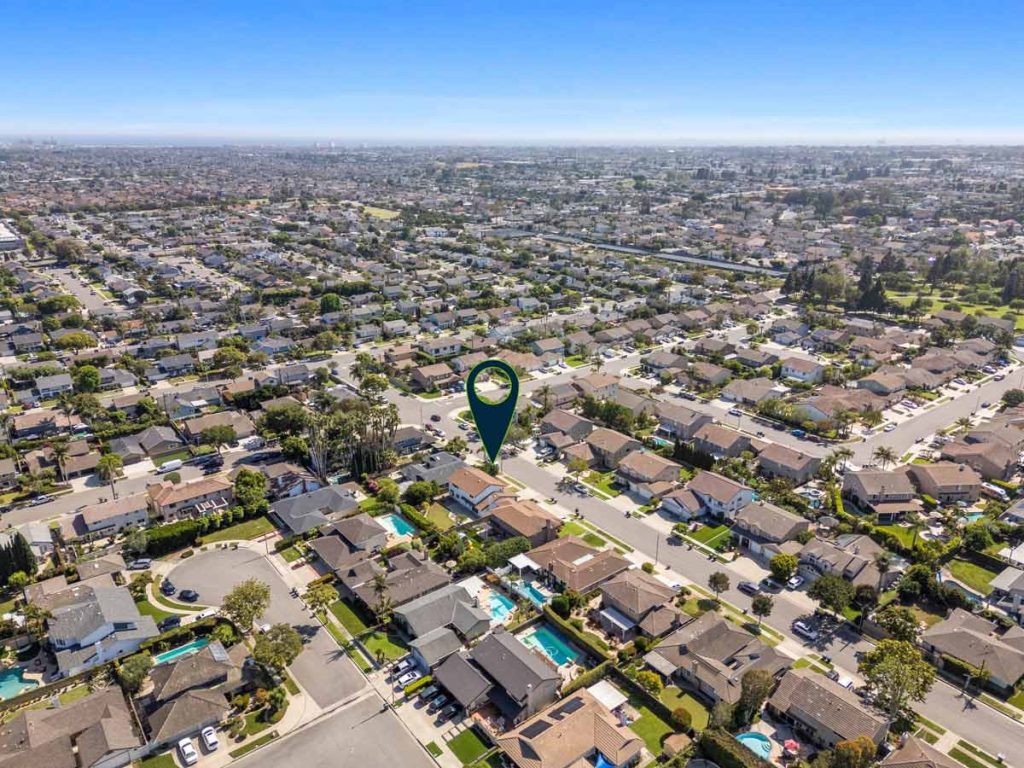 aerial view of fountain valley neighborhood with arrow pointing to house for sale