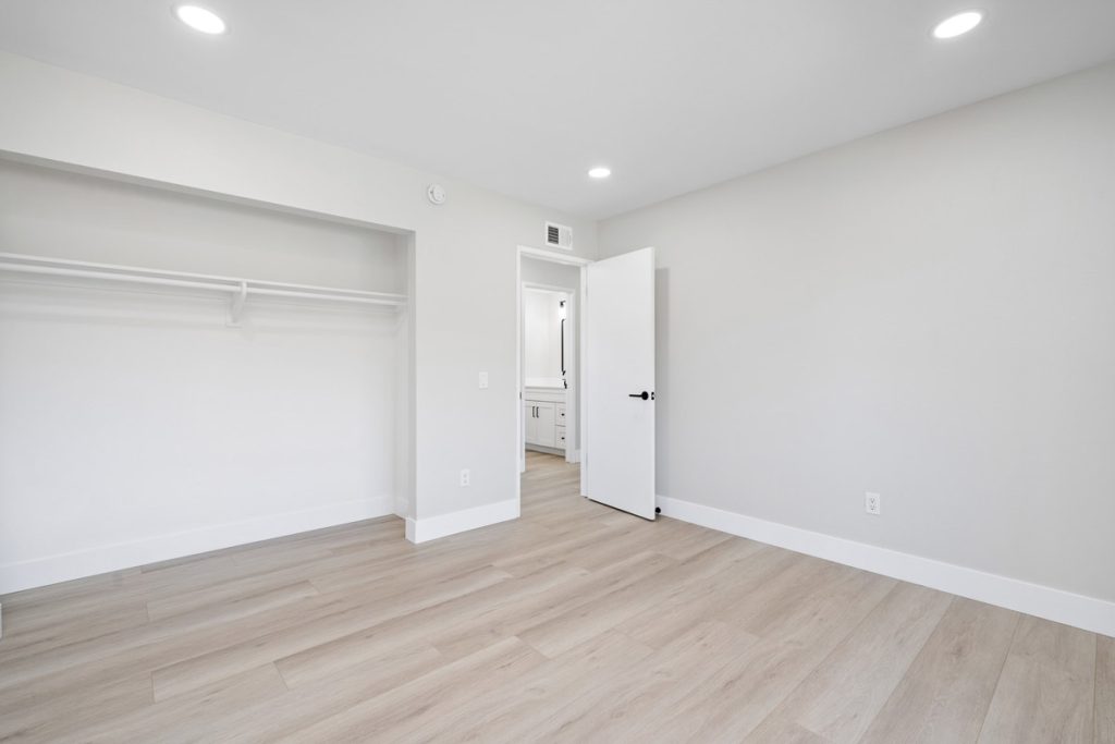 empty bedroom with neutral floors and walls.