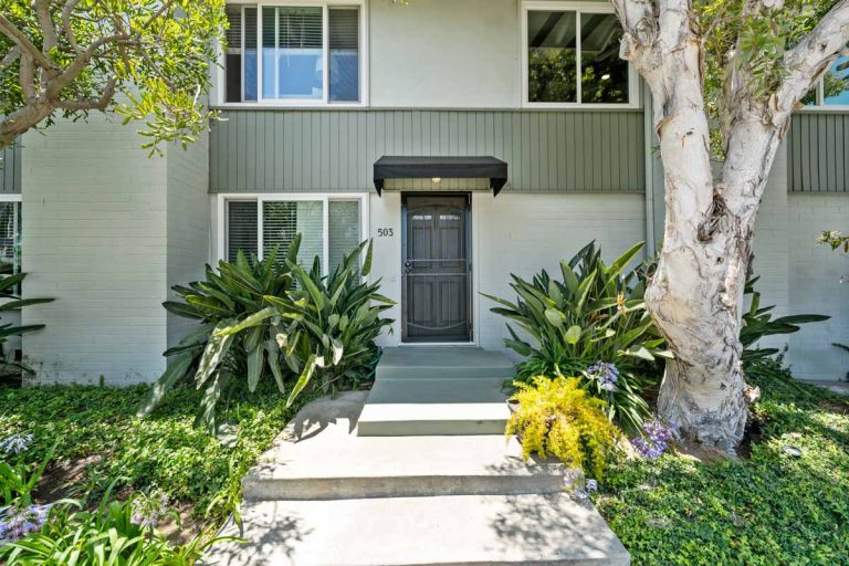 exterior of 503 Saint Andrews Road, Newport Beach showing lush plants, front door and windows