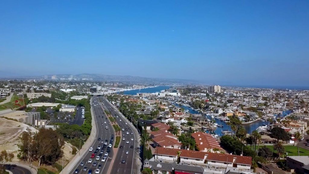 view of pacific coast highway with harbor and buildings