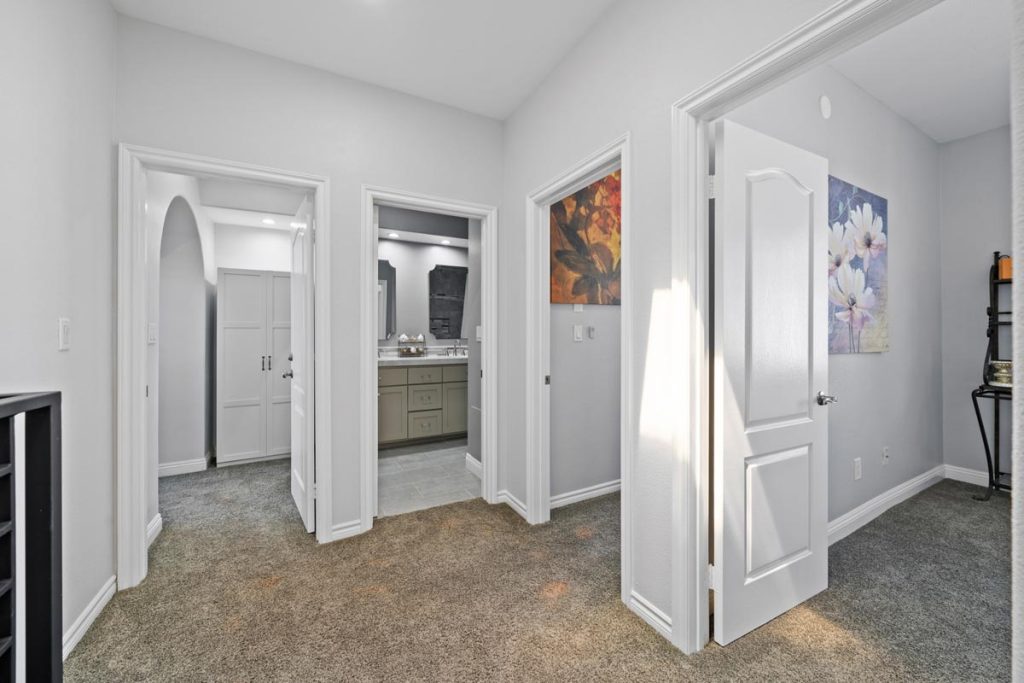 carpeted landing between bedrooms and shared bathroom