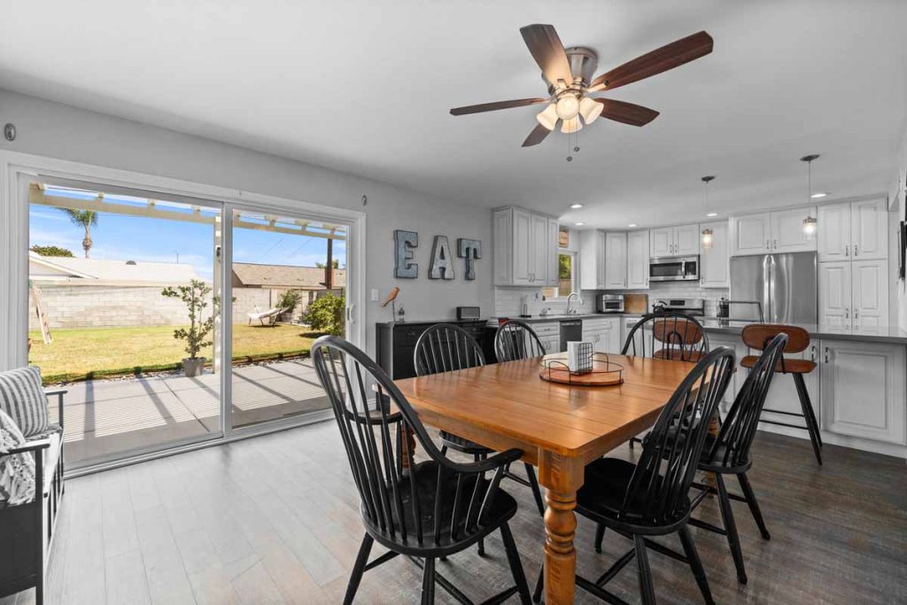 kitchen table with sliding glass doors leading to backyard