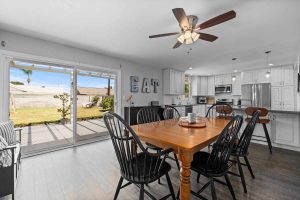 kitchen table with sliding glass doors leading to backyard