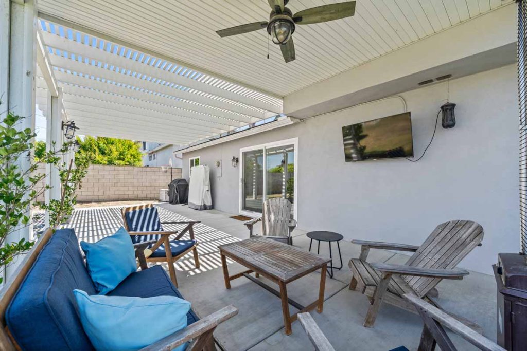 covered patio with seating and small table