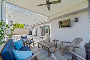 covered patio with seating and small table