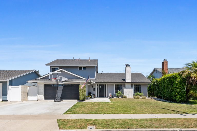 exterior view of front of 2-story home with grass