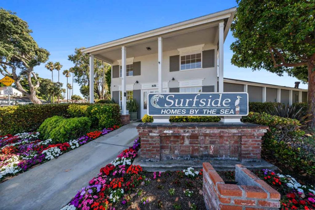 entry to community showing sign that reads surfside homes by the sea.