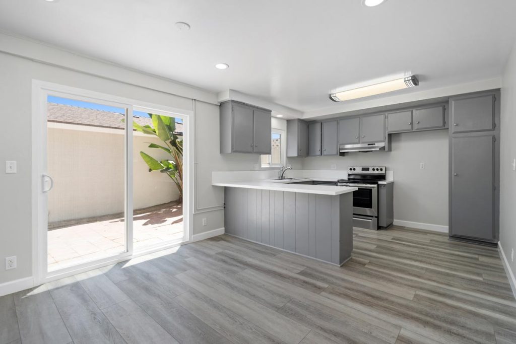 neutral updated kitchen with white stone countertops and gray cabinets