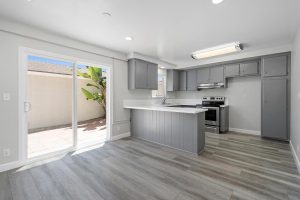 neutral updated kitchen with white stone countertops and gray cabinets