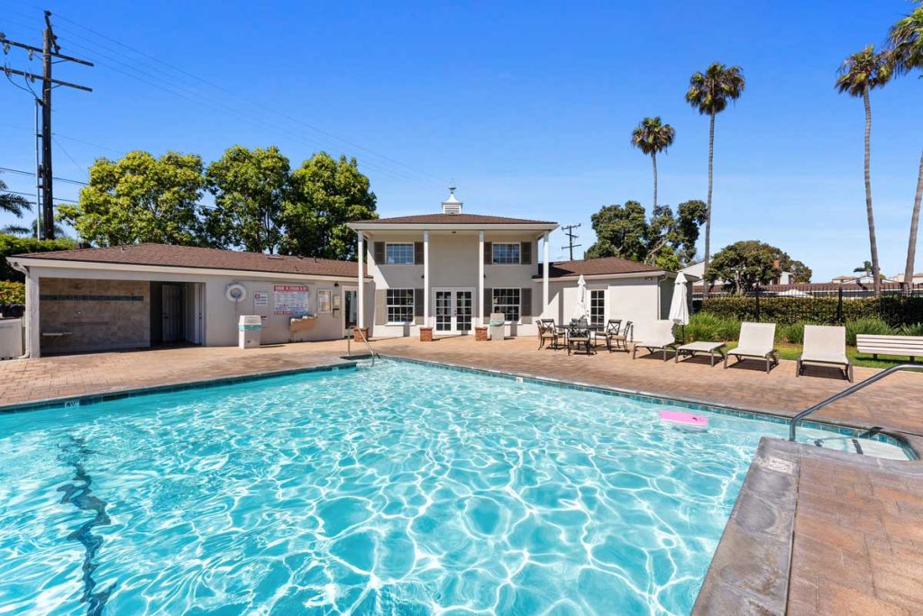 community pool with crystal clear, sparkling water and chaise lounge chairs