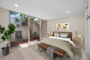 staged bedroom with a neutral color palate that has a sliding glass door to the backyard.