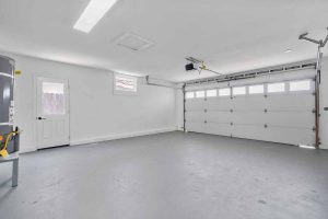 An empty, clean and bright garage with epoxy floors.