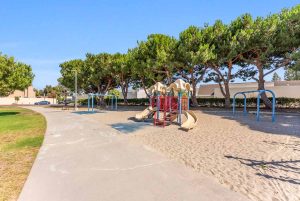 Community playground with sand and a play structure.