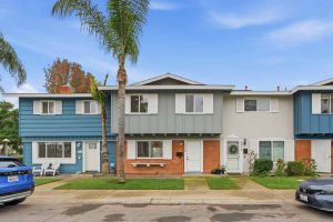 Front of townhouse showing brick lower portion and gray higher portion.