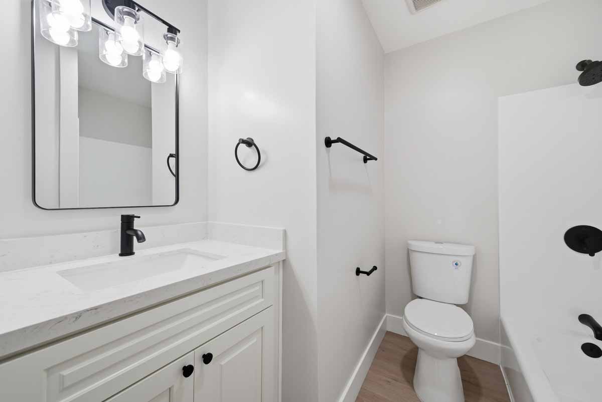 An updated white and black bathroom.