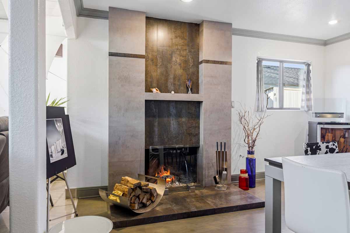 Updated, modern fireplace with gray/beige tones.