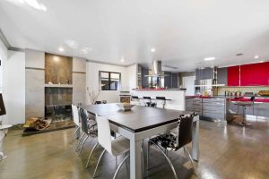 Dining room with view of fireplace and kitchen.