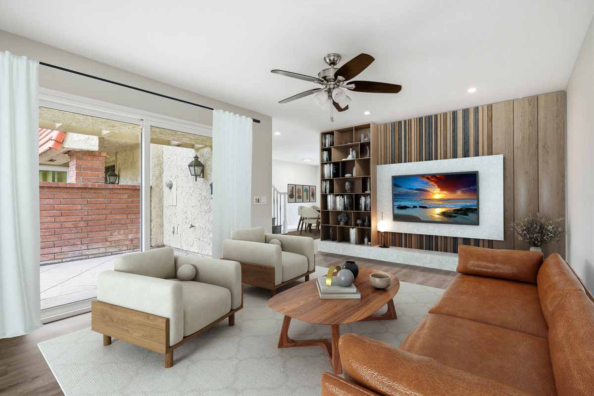 Digitally staged living room with couch, two chairs, a ceiling fan, sliding glass doors to patio.