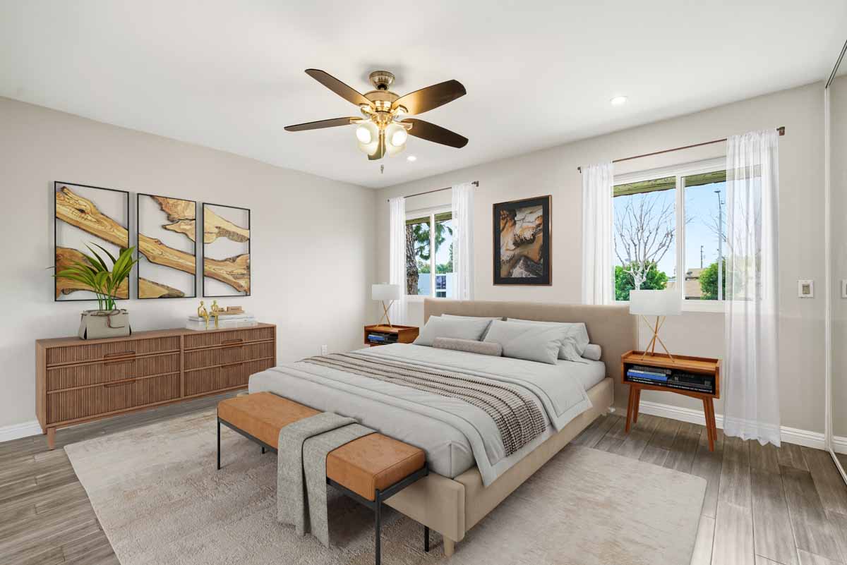 Digitally staged master bedroom with ceiling fan, large bed, two windows with night stands underneath and a dresser.
