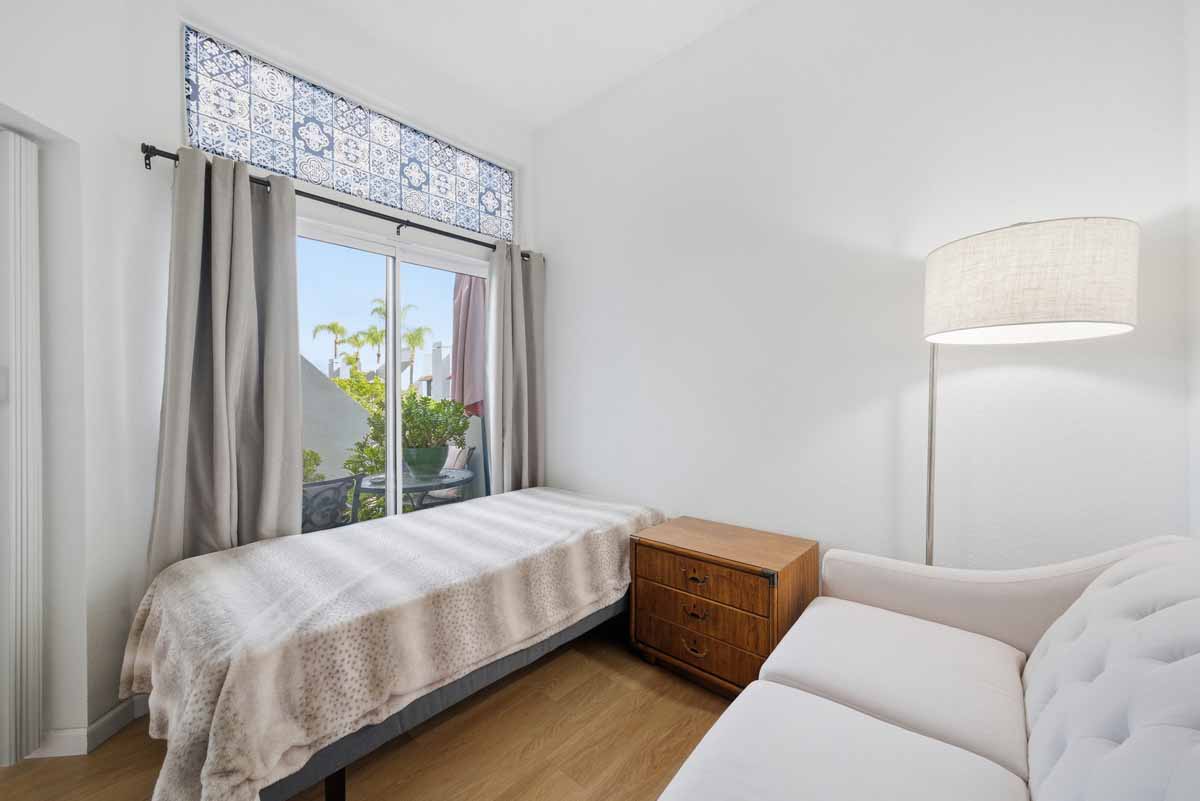 Guest bedroom with a small bed and couch.