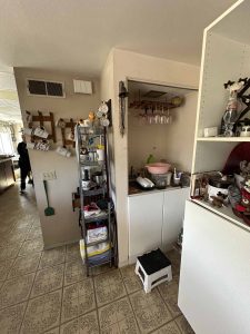 Outdated kitchen with linoleum floors.