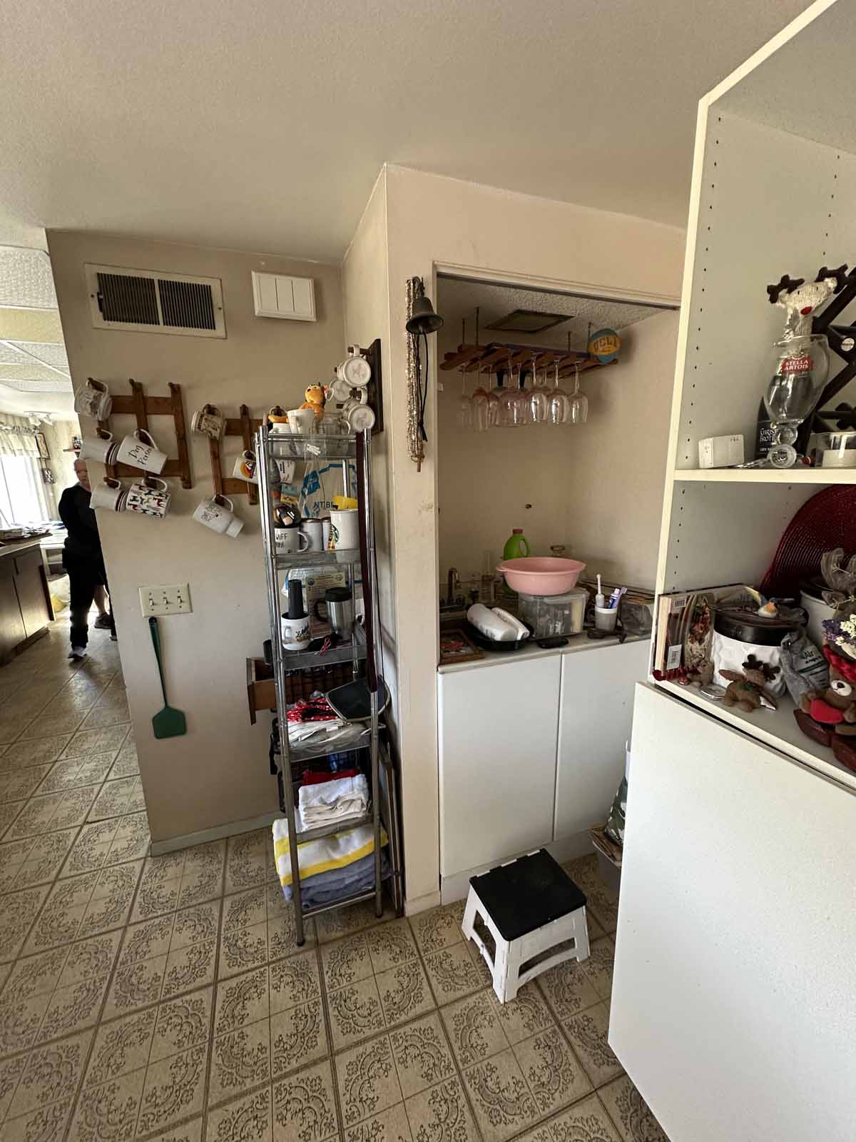 Outdated kitchen with linoleum floors.