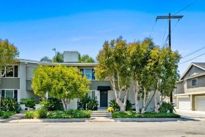 Exterior of 503 Saint Andrews Road, Newport Beach showing lush plants, front door and windows.