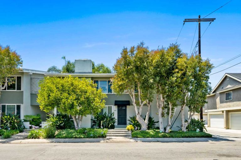 Exterior of 503 Saint Andrews Road, Newport Beach showing lush plants, front door and windows.