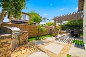 backyard with stacked stone barbecue.