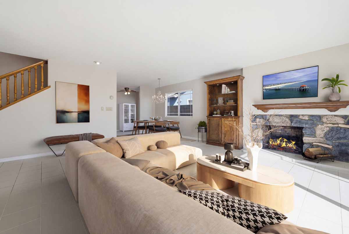 Virtually staged living room with couch , coffee table and fireplace.